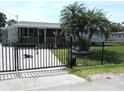 Charming single-story home featuring a well-maintained front yard and a secure gated entrance at 523 Oliphant Ln, Punta Gorda, FL 33950