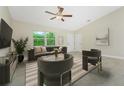 Comfortable living room featuring tile flooring, a modern ceiling fan, recessed lighting and stylish decor at 5354 Wagon Wheel Dr, North Port, FL 34291