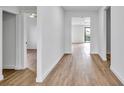 Bright hallway with wood-look flooring leading to various rooms at 551 Crandall Nw St, Port Charlotte, FL 33952