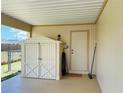 Covered patio featuring a utility shed for extra storage and adjacent hose hookup at 6327 Fabian Rd, North Port, FL 34287