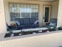 Enjoy the outdoors in a cozy front patio area with comfortable seating and plant garden at 6327 Fabian Rd, North Port, FL 34287