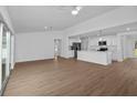 Open-concept living space with hardwood floors and sliding glass doors to the backyard at 1589 Boswell St, North Port, FL 34288