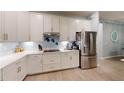 Modern kitchen featuring white cabinets, stainless steel appliances, and an induction cooktop at 17420 Jadestone Ct, Venice, FL 34293