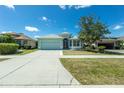 Attractive home boasts a lush green lawn and inviting curb appeal at 2241 Boxwood St, North Port, FL 34289
