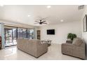 Inviting living room with modern lighting, neutral walls, and a sliding glass door offering outdoor view at 2368 Pellam Blvd, Port Charlotte, FL 33948