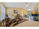Spacious living room featuring tile flooring, vaulted ceilings, and sliding glass doors for ample natural light at 25313 Durango Ct, Punta Gorda, FL 33955