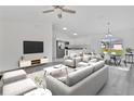 Bright, open-concept living space with modern furnishings, a dining area, and seamless flow into the kitchen at 26384 Flower Rd, Punta Gorda, FL 33955