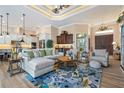 Bright and airy living room featuring high ceilings, pendant lights, and an open floor plan at 2850 Magdalina Dr, Punta Gorda, FL 33950