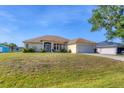 Charming single-story home featuring an attached two-car garage and well-maintained front lawn at 3935 Nemo Ave, North Port, FL 34287