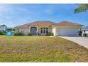Charming single-story home featuring an attached two-car garage and well-maintained front lawn at 3935 Nemo Ave, North Port, FL 34287