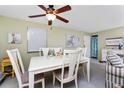 Bright dining area with a ceiling fan and a decorative table setting at 4022 Beaver Ln # 500C, Port Charlotte, FL 33952