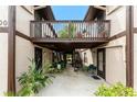 Charming condo entrance featuring a lovely courtyard and stairs to the upper level at 4022 Beaver Ln # 500C, Port Charlotte, FL 33952