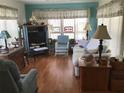 Inviting living room with cozy furniture, natural light and elegant window treatments at 5048 Palena Blvd, North Port, FL 34287
