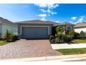 Beautiful single-story home with brick paved driveway, manicured lawn and tropical landscaping at 5309 Shell Mound Cir, Punta Gorda, FL 33982