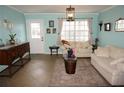 Cozy living room with tile floors, neutral furniture, and ample natural light through large windows at 6249 Drucker Cir, Port Charlotte, FL 33981