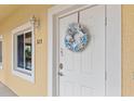 Charming condo entrance featuring a decorative wreath and a welcoming, well-lit doorway at 7196 N Plum Tree # 323, Punta Gorda, FL 33955