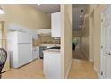 Bright kitchen with white cabinets, stainless steel appliances, and an open layout at 7196 N Plum Tree # 323, Punta Gorda, FL 33955