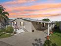 Charming home boasts covered parking, an inviting front porch and landscaping at 724 Blackburn Blvd, North Port, FL 34287