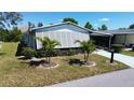 Charming home featuring mature landscaping with shutters for privacy and shade at 861 Seabrooke Dr, Englewood, FL 34223