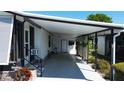 Covered patio with privacy trellis and access to the main dwelling at 861 Seabrooke Dr, Englewood, FL 34223