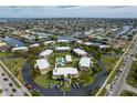 Aerial view of condos with central pool, circular drive, ample parking, and waterway views at 1080 Bal Harbor Blvd # 10C, Punta Gorda, FL 33950