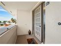 Inviting condo front door with welcome mat and unit number, offering a glimpse of the neighborhood at 1080 Bal Harbor Blvd # 10C, Punta Gorda, FL 33950