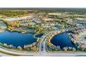 An aerial view of a community with multiple ponds and water features surrounded by wooded areas at 1352 Raspberry Dr, North Port, FL 34289