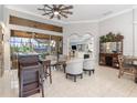Open living space with tiled floors, high ceilings, wet bar, and access to the outdoor patio at 15618 Aqua Cir, Port Charlotte, FL 33981