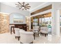 Comfortable seating area with tiled floors, high ceilings, wet bar, and backyard views at 15618 Aqua Cir, Port Charlotte, FL 33981