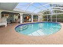 Enclosed pool area featuring a sparkling blue pool, ample seating, and a relaxing atmosphere at 17342 Foremost Ln, Port Charlotte, FL 33948