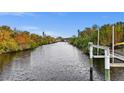 Scenic water view of the canal with lush greenery on both shorelines from the property at 17342 Foremost Ln, Port Charlotte, FL 33948