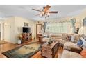 Inviting living room with a comfortable sectional sofa, rustic decor, and lots of natural light at 18446 Burkholder Cir, Port Charlotte, FL 33948
