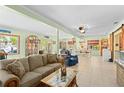 Spacious living room flowing into dining area, featuring tile floors and lots of natural light at 18446 Burkholder Cir, Port Charlotte, FL 33948