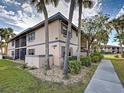 Condo exterior showcasing well-maintained landscaping and architectural details at 19505 Quesada Ave # Ee202, Port Charlotte, FL 33948