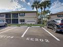 Exterior shot of condo building with dedicated parking spots visible at 19505 Quesada Ave # Ee202, Port Charlotte, FL 33948