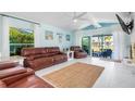 Comfortable living room with a ceiling fan, sliding glass doors, and stylish decor at 1960 W Marion Ave, Punta Gorda, FL 33950