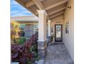 Inviting covered front porch with stone columns, lush landscaping, and a welcoming entrance at 2304 Bonn Ct, Punta Gorda, FL 33983