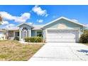 Attractive single-story home featuring tidy landscaping, a two-car garage, and a pleasant front entrance at 23482 Moreland Ave, Port Charlotte, FL 33954