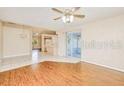 Open-concept living space showcasing hardwood floors, neutral walls, and a seamless transition to the kitchen at 23482 Moreland Ave, Port Charlotte, FL 33954