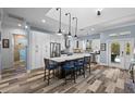 Modern kitchen with stainless steel appliances, granite counters, and a large island at 303 W Grace St, Punta Gorda, FL 33950