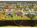 Expansive aerial view of the property backing onto a canal, showcasing the pool and surrounding greenery at 32 Long Meadow Ln, Rotonda West, FL 33947