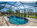 Inviting screened-in pool area with a tranquil water view, perfect for relaxation and outdoor enjoyment at 32 Long Meadow Ln, Rotonda West, FL 33947