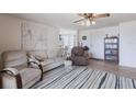 Comfortable living room featuring a striped rug, neutral furniture, and serene artwork at 3249 Sunrise Trl, Port Charlotte, FL 33952