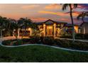 Beautiful home exterior at sunset with lush landscaping, a metal roof, and inviting entrance at 3657 Aruba Ct, Punta Gorda, FL 33950