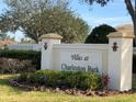 Welcoming entrance sign for Villas at Charleston Park, surrounded by lush landscaping and beautiful flowers at 6379 Grand Cypress Blvd, North Port, FL 34287