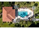 Aerial view of a luxurious community pool with lounge chairs and lush landscaping at 95 N Marion Ct # 226, Punta Gorda, FL 33950