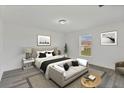 Cozy bedroom with a large window, neutral décor, and sitting area at 11456 5Th Ave, Punta Gorda, FL 33955