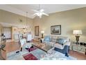 Bright living room with vaulted ceiling, ceiling fan, hardwood floors, and comfortable furnishings at 1235 Saxony Cir # 5202, Punta Gorda, FL 33983