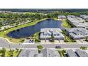 Beautiful aerial view of townhomes and a lake in a lush community with a golf course at 14617 Sycamore Ct # 2211, Punta Gorda, FL 33955