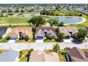 Beautiful aerial view of home overlooking water with golf course, showcasing landscaping and community at 1872 Birmingham Blvd, Port Charlotte, FL 33980